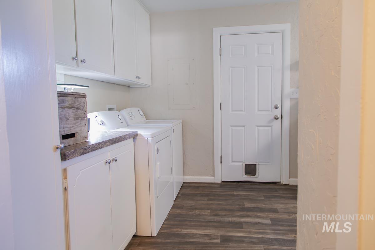 1404 Rochester Street Caldwell, ID 83605 - Photo 17 of 29 Dedicated utility area featuring white cabinetry, a speckled countertop, and wood-finish flooring