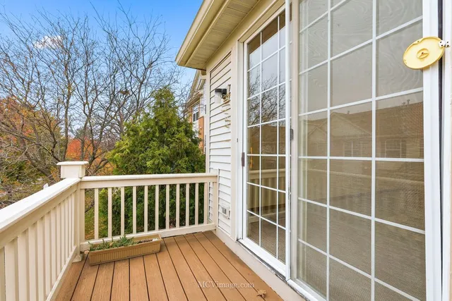 a view of a balcony with a floor to ceiling window with wooden fence