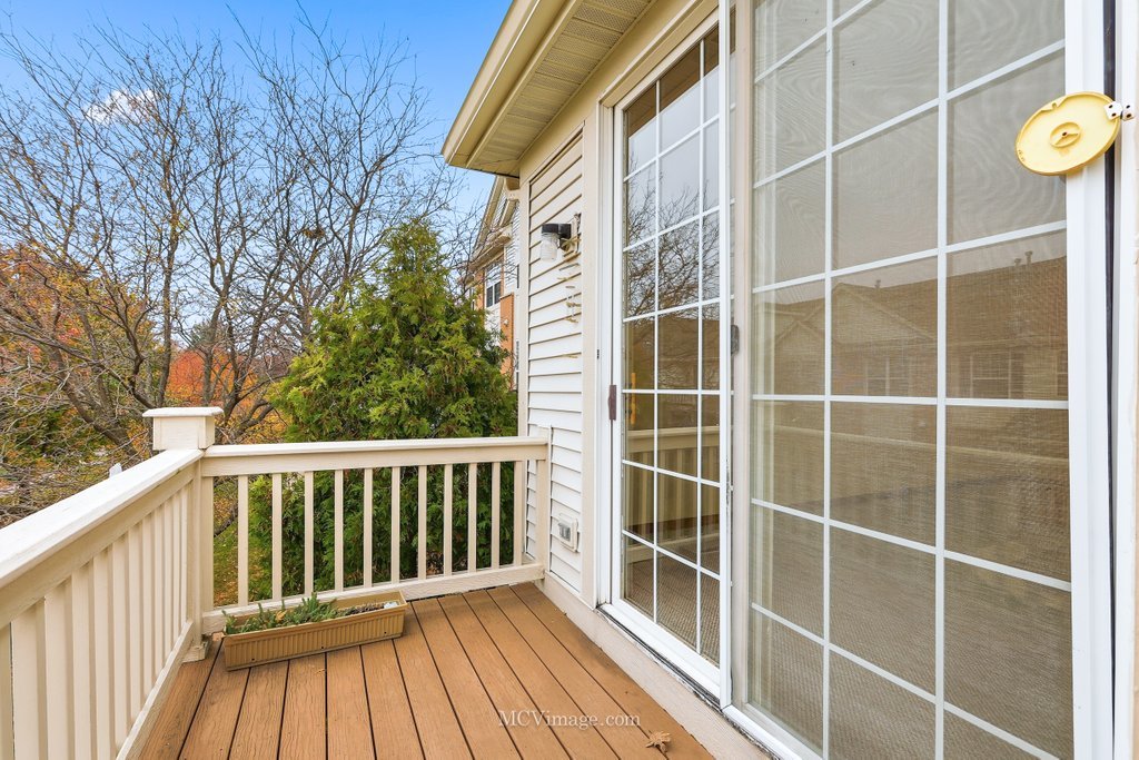 9017 Concord Lane, Unit L Justice, IL 60458 - Photo 19 of 20 a view of a balcony with a floor to ceiling window with wooden fence