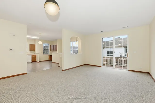 a view of a big room with windows and chandelier