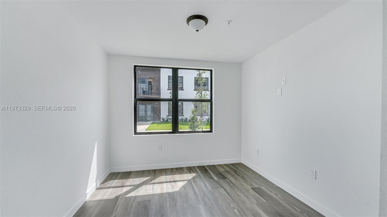 13375 Southwest 250th Street, Unit 104 Homestead, FL 33032 - Photo 11 of 27 an empty room with windows