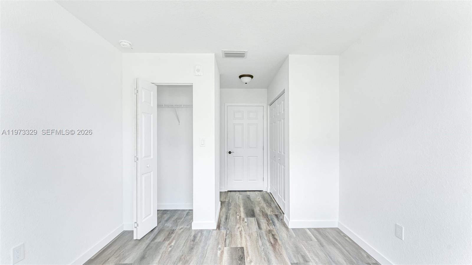 13375 Southwest 250th Street, Unit 104 Homestead, FL 33032 - Photo 12 of 27 a view of a room with wooden floor and a bathroom