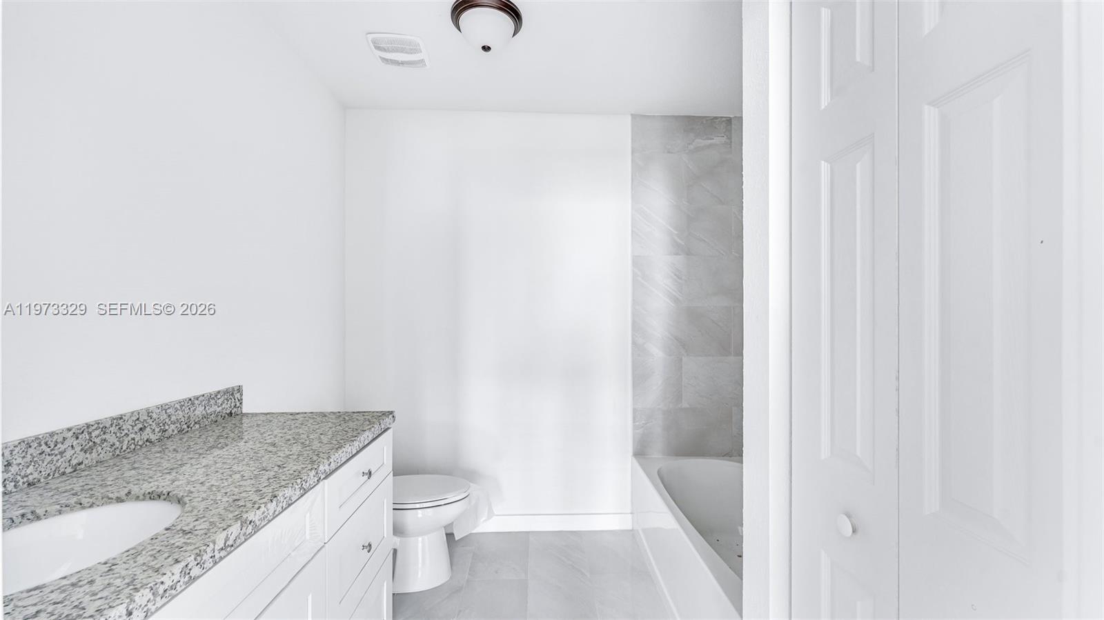 13375 Southwest 250th Street, Unit 104 Homestead, FL 33032 - Photo 14 of 27 a bathroom with a granite countertop sink toilet and shower
