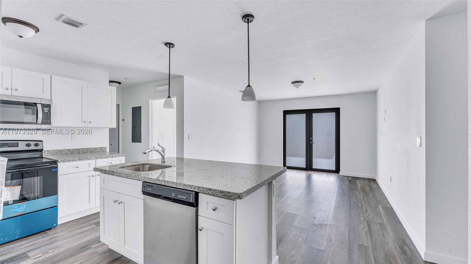 13375 Southwest 250th Street, Unit 104 Homestead, FL 33032 - Photo 18 of 27 a kitchen with granite countertop a sink appliances and cabinets