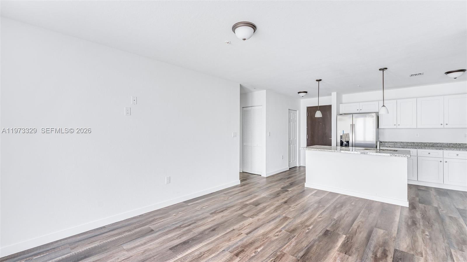 13375 Southwest 250th Street, Unit 104 Homestead, FL 33032 - Photo 21 of 27 a view of kitchen with wooden floor