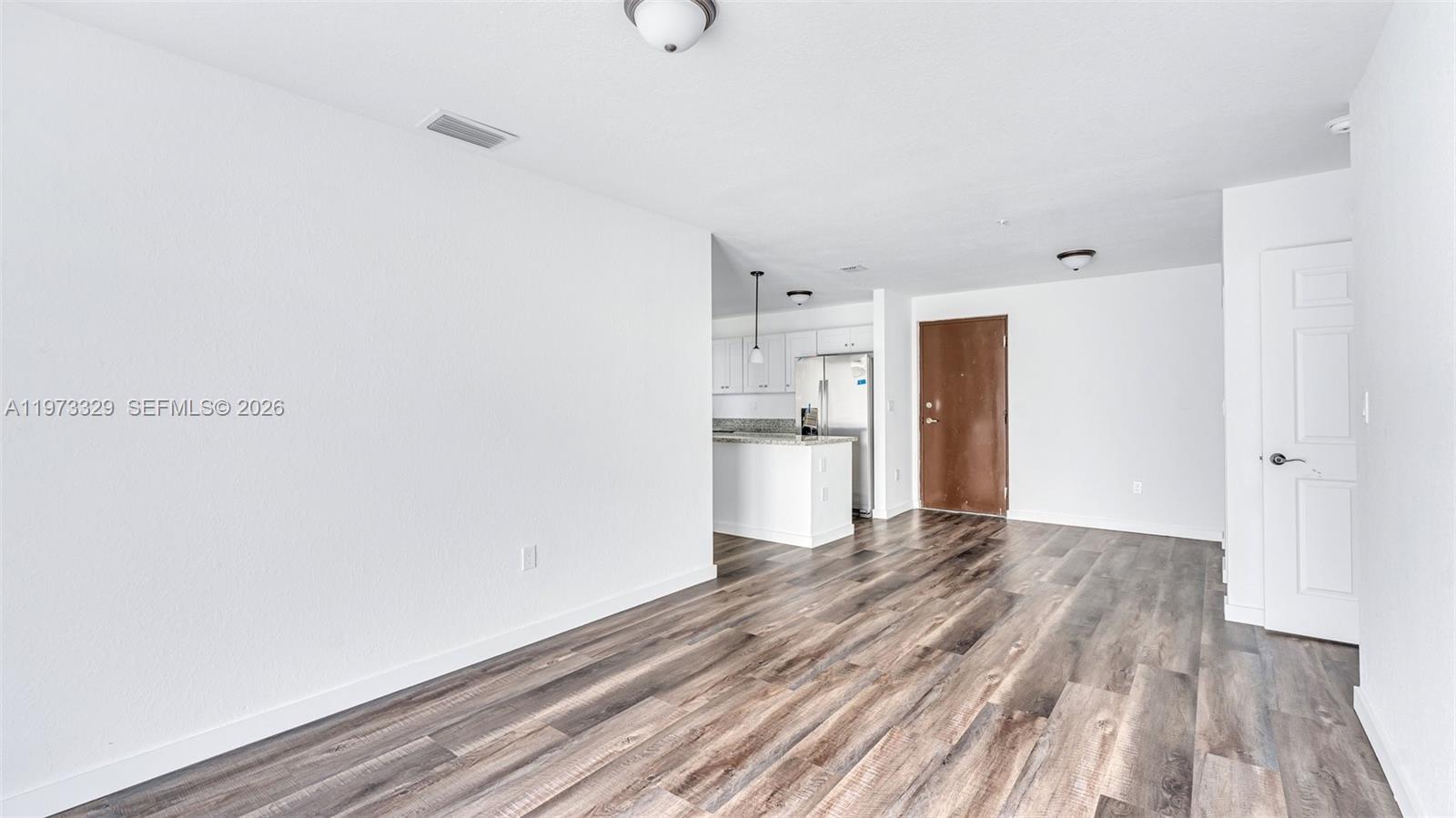 13375 Southwest 250th Street, Unit 104 Homestead, FL 33032 - Photo 4 of 27 a view of kitchen with wooden floor