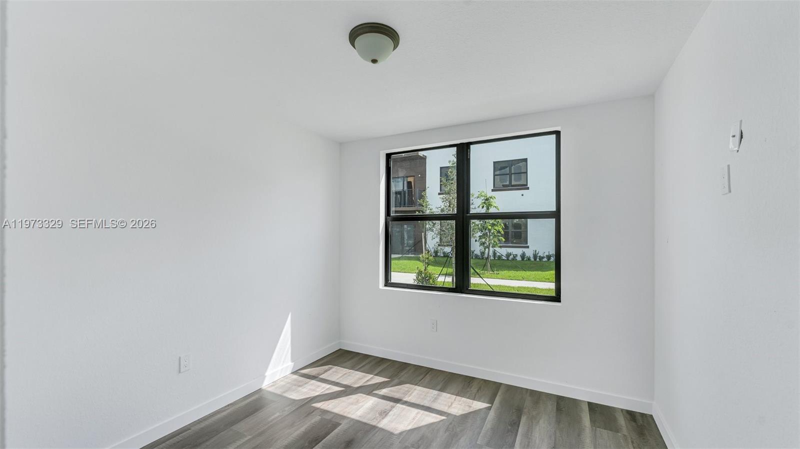 13375 Southwest 250th Street, Unit 104 Homestead, FL 33032 - Photo 5 of 27 an empty room with windows