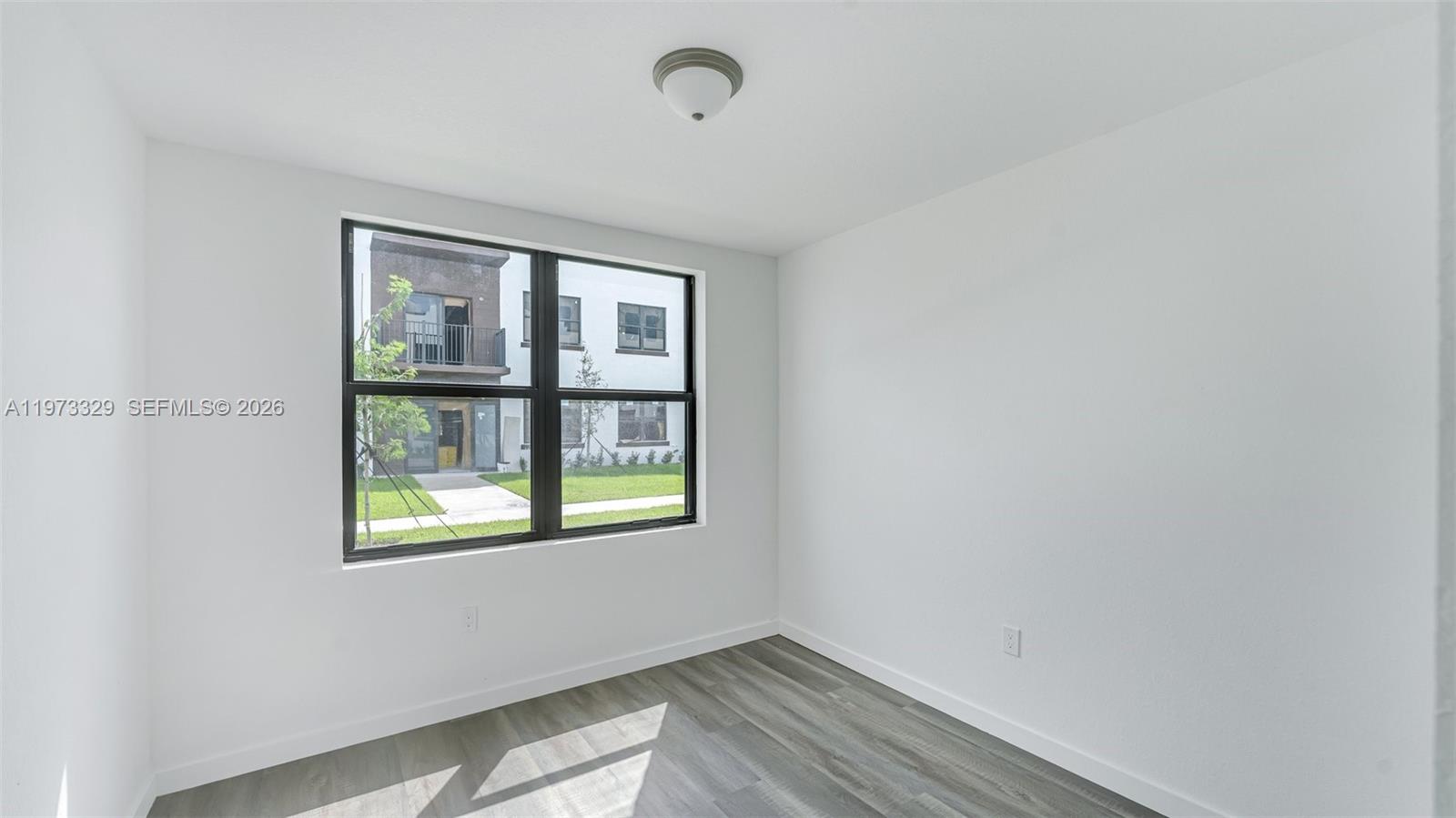 13375 Southwest 250th Street, Unit 104 Homestead, FL 33032 - Photo 6 of 27 an empty room with a window
