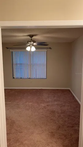 a view of a livingroom with a ceiling fan and hardwood floor