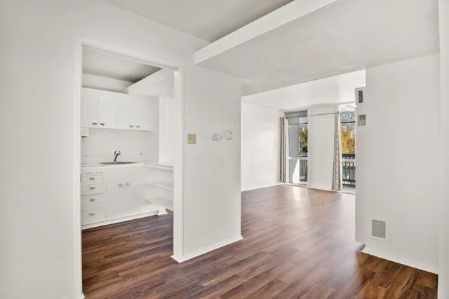 a view of a hallway with wooden floor