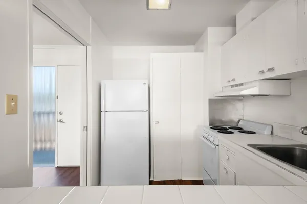 a kitchen with stainless steel appliances a refrigerator and cabinets