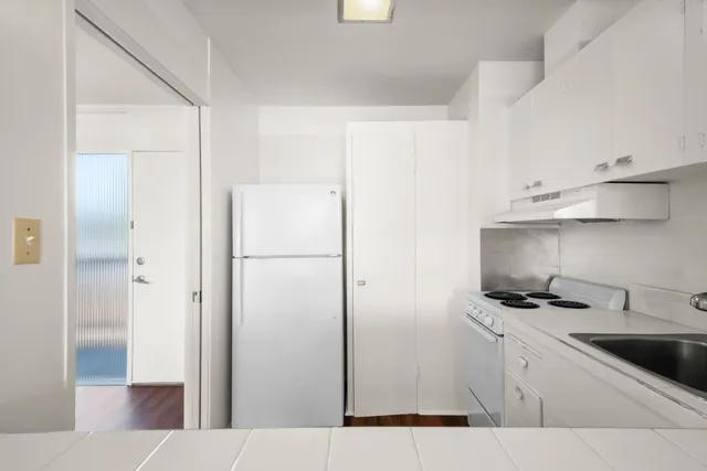 a kitchen with stainless steel appliances a refrigerator and cabinets