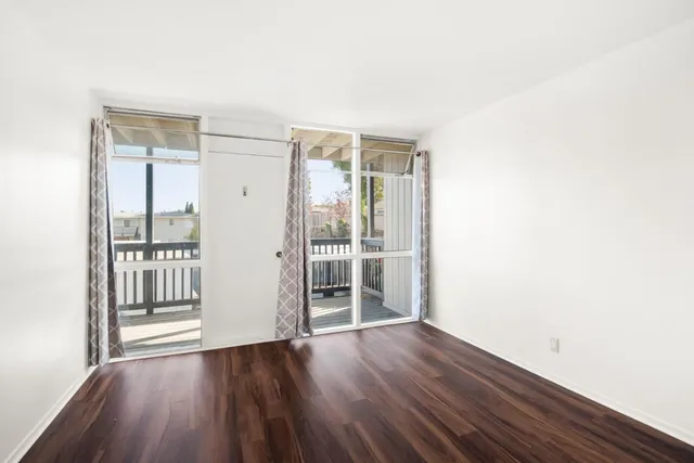 a view of wooden floor and windows in a room