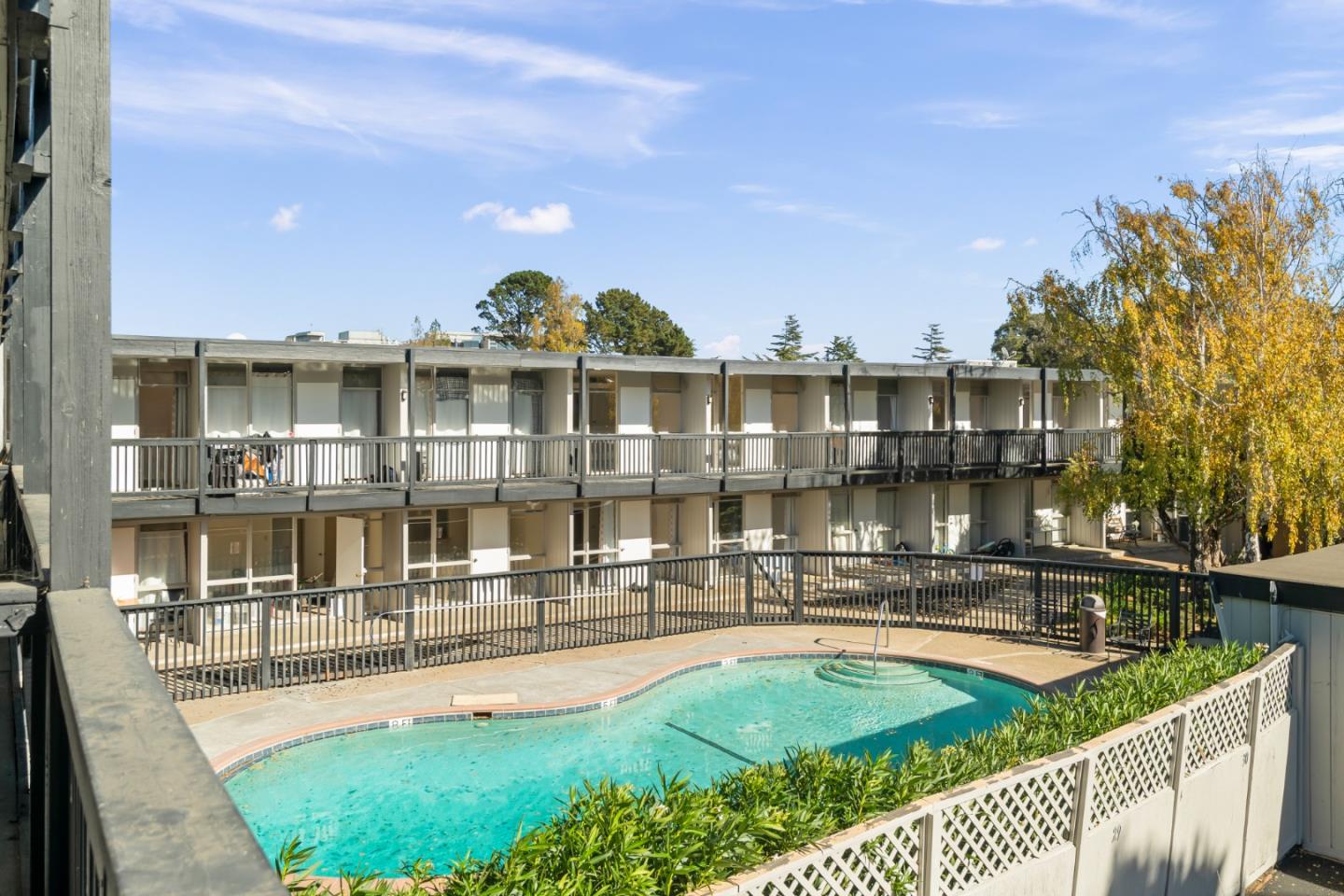 1775 Marco Polo Way Burlingame, CA 94010 - Photo 22 of 23 a view of a swimming pool with an outdoor seating and a garden
