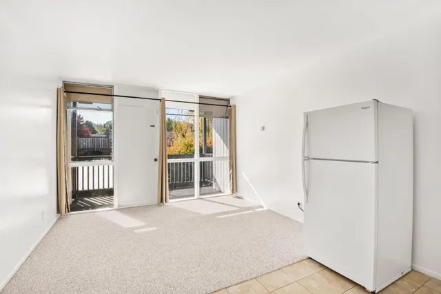 a view of a room with wooden floor and windows