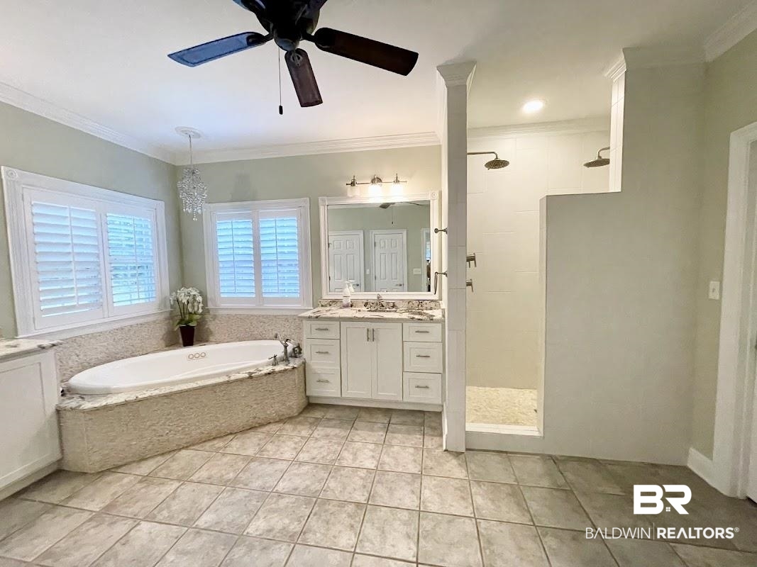202 Potters Mills Road Daphne, AL 36526 - Photo 15 of 29 Bathroom featuring vanity, tile patterned floors, ceiling fan, independent shower and bath, and crown molding