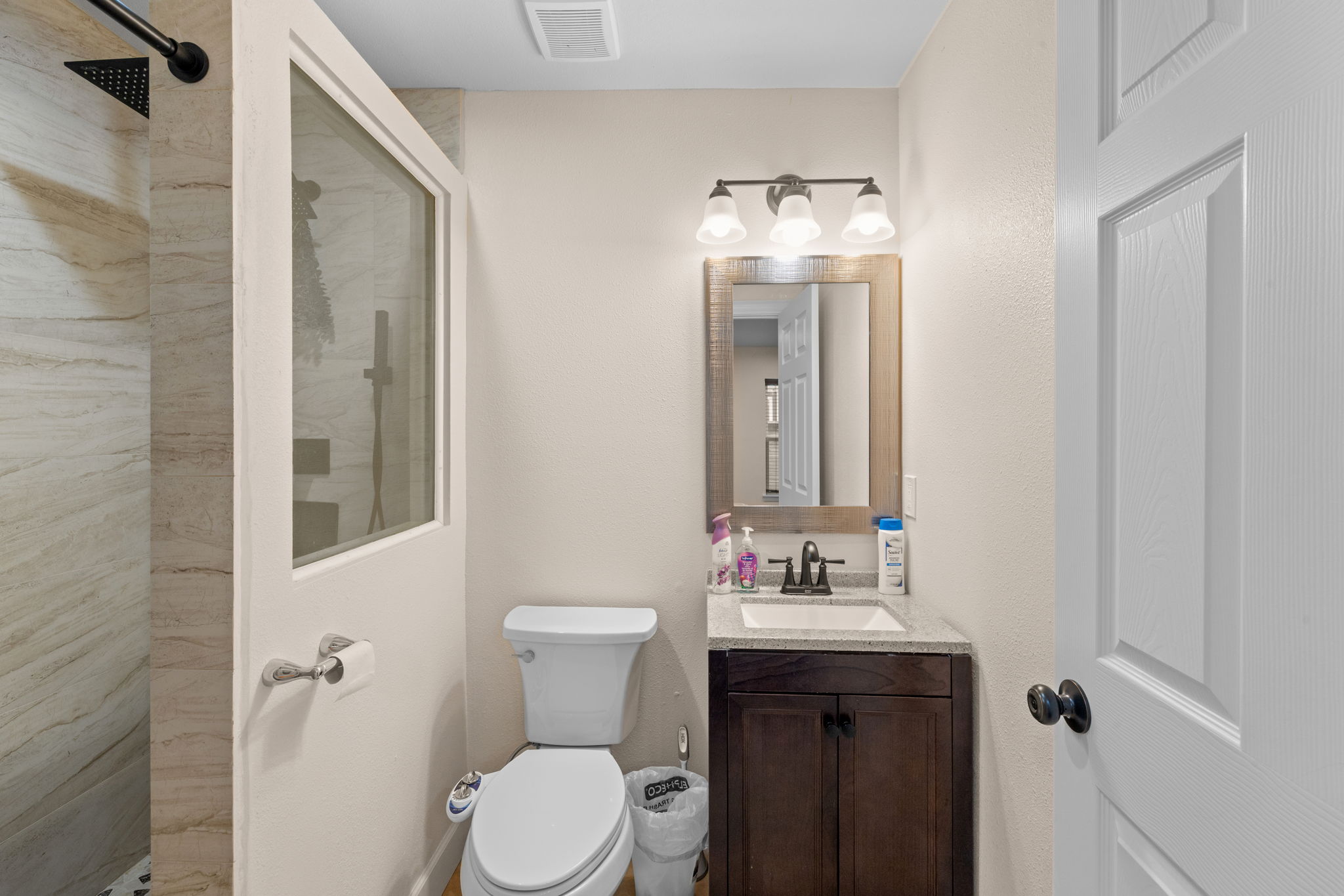 907 East 53rd Street Austin, TX 78751 - Photo 28 of 36 A well-appointed bathroom with a modern shower, vanity, and ample lighting.