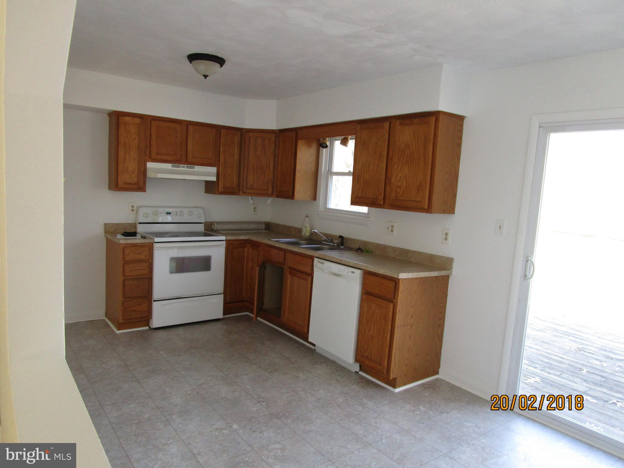 3534 Arters Mill Road Westminster, MD 21158 - Photo 2 of 13 a kitchen with stainless steel appliances granite countertop a stove a sink and a microwave
