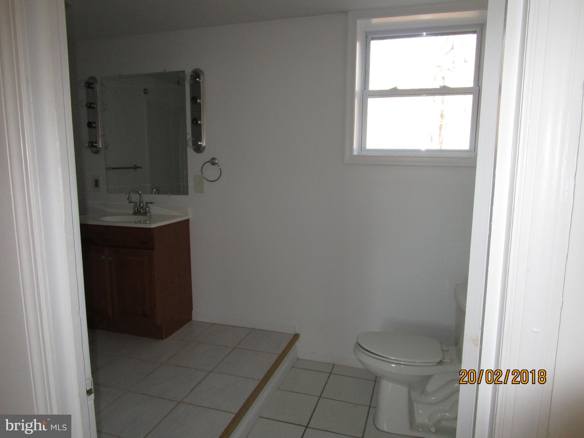 3534 Arters Mill Road Westminster, MD 21158 - Photo 13 of 13 a bathroom with a sink a toilet and window