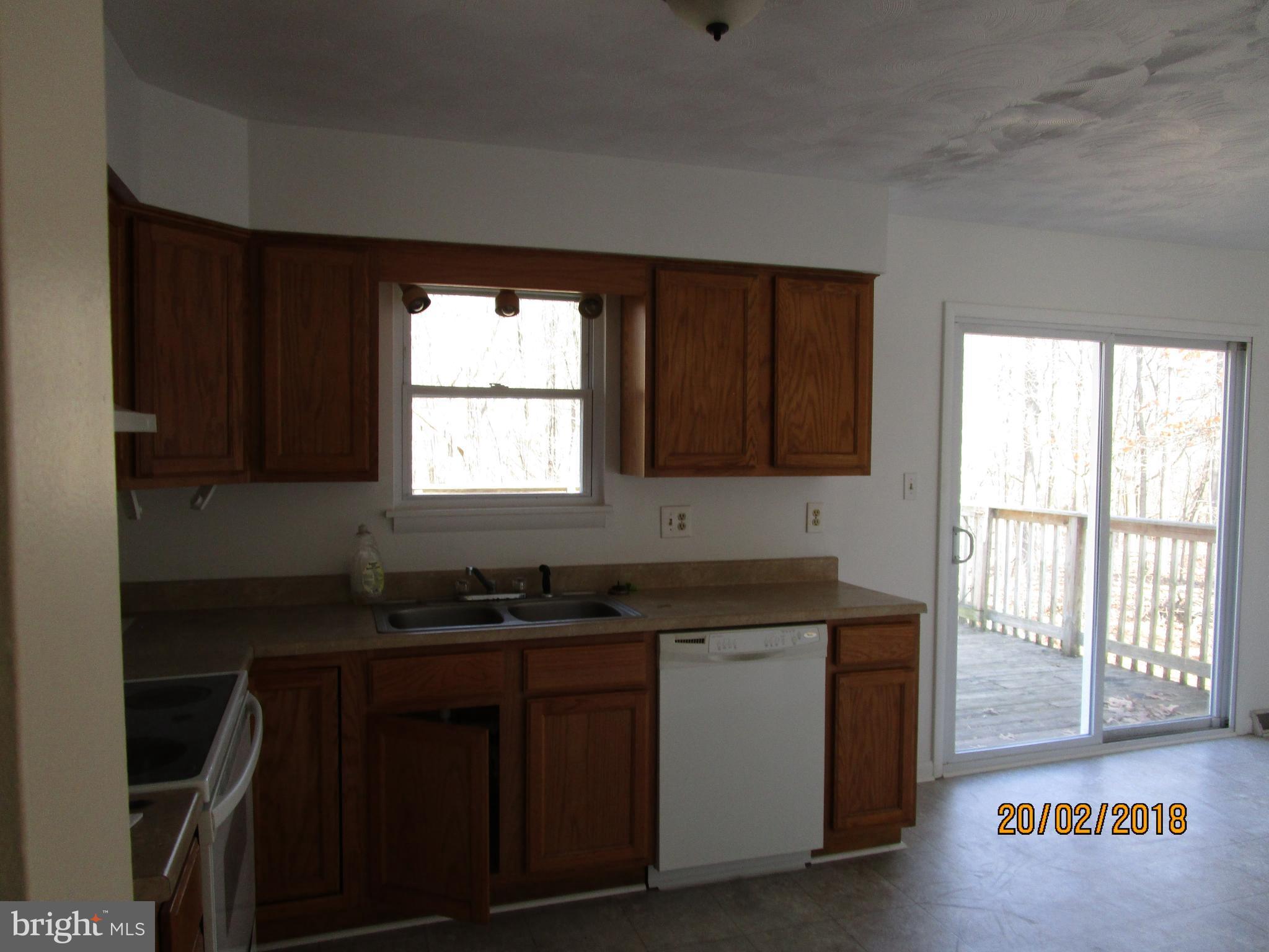 3534 Arters Mill Road Westminster, MD 21158 - Photo 3 of 13 a kitchen with granite countertop a sink window and cabinets
