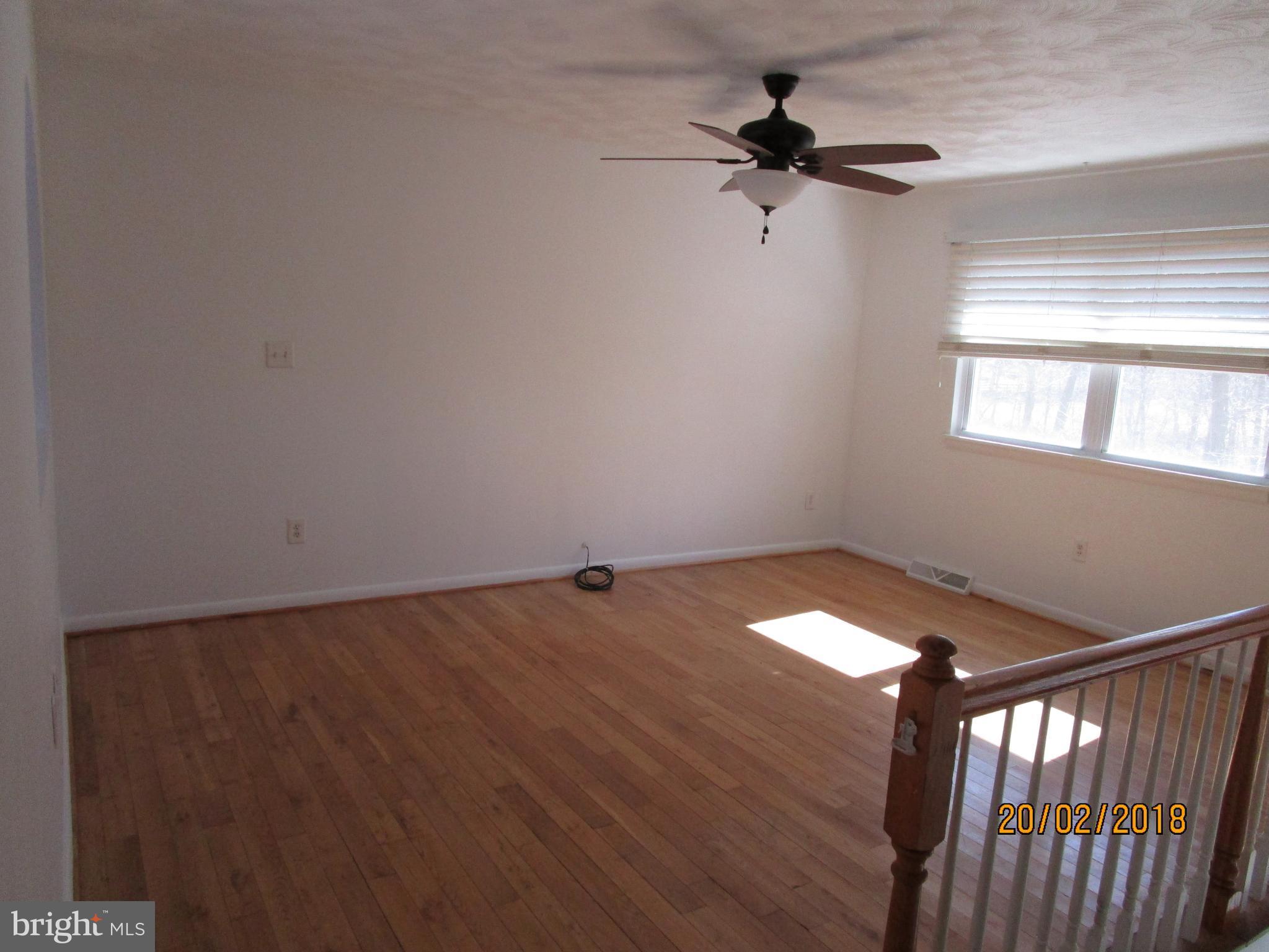 3534 Arters Mill Road Westminster, MD 21158 - Photo 4 of 13 a view of empty room with wooden floor and fan