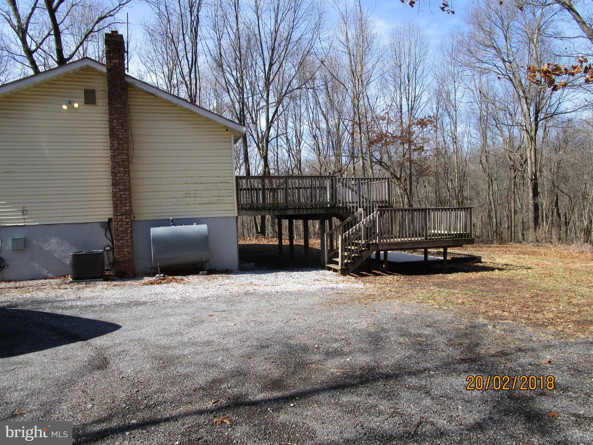 3534 Arters Mill Road Westminster, MD 21158 - Photo 10 of 13 a backyard of a house with barbeque oven and trees