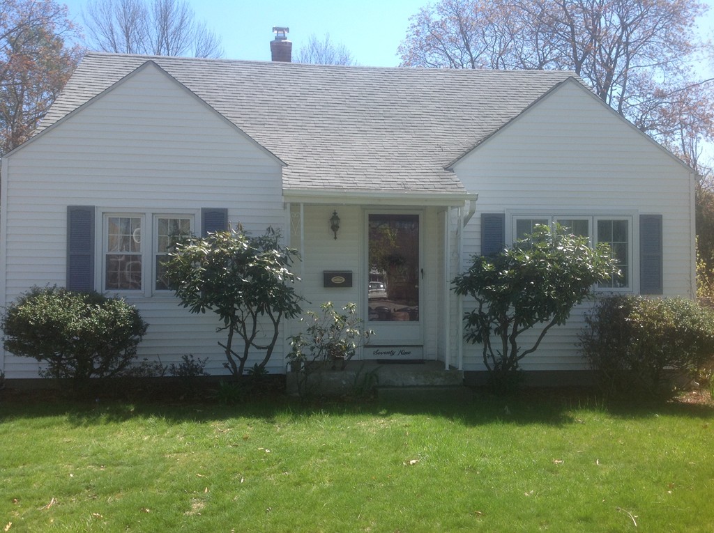 a front view of house with a garden