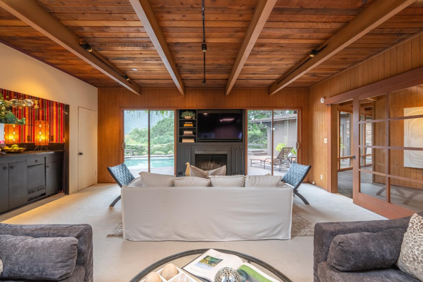 46 Middle Canyon Road Carmel Valley, CA 93924 - Photo 8 of 74 a living room with furniture a flat screen tv and a large window