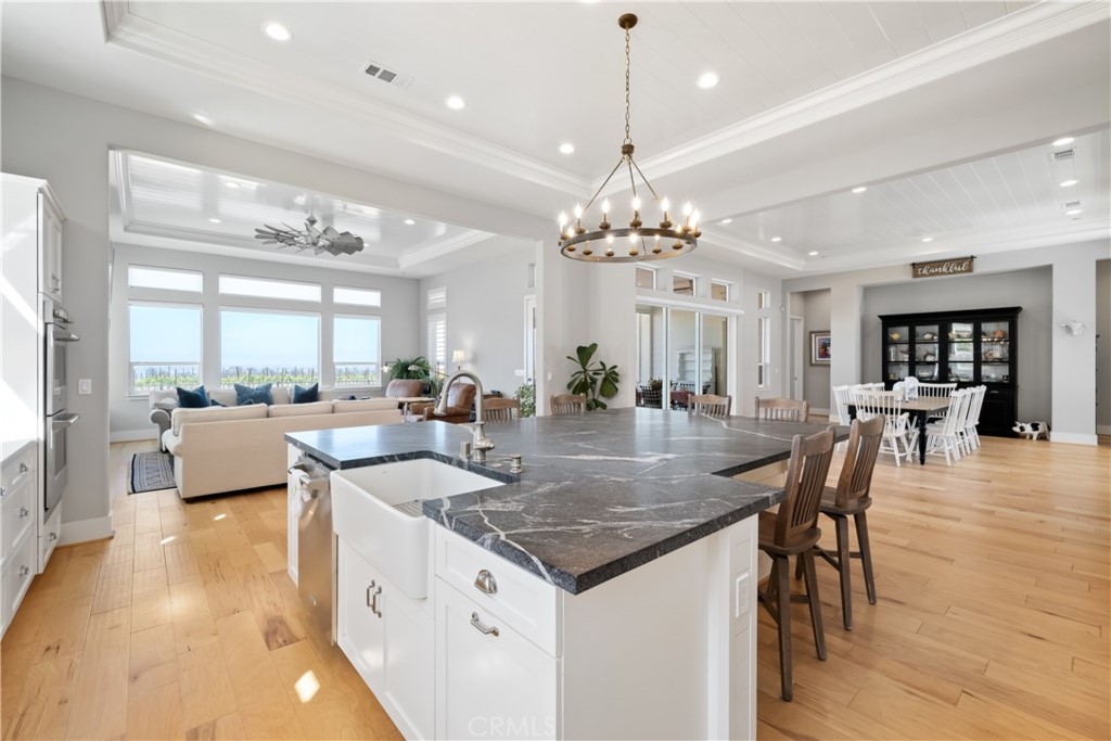 1594 Eucalyptus Road Nipomo, CA 93444 - Photo 15 of 75 a view of a dining room and livingroom with furniture wooden floor a chandelier