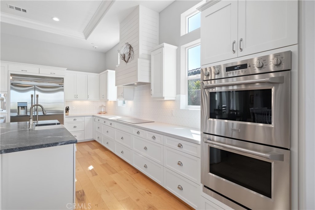 1594 Eucalyptus Road Nipomo, CA 93444 - Photo 16 of 75 a kitchen with granite countertop white cabinets and white appliances