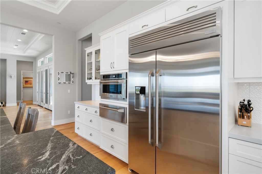 1594 Eucalyptus Road Nipomo, CA 93444 - Photo 18 of 75 a kitchen with stainless steel appliances kitchen island granite countertop a refrigerator and cabinets