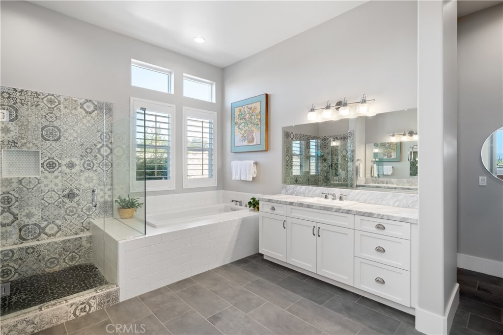 1594 Eucalyptus Road Nipomo, CA 93444 - Photo 39 of 75 a bathroom with a granite countertop tub a sink and a large mirror