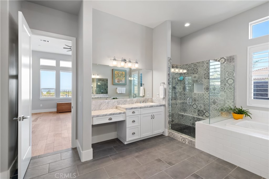 1594 Eucalyptus Road Nipomo, CA 93444 - Photo 40 of 75 a bathroom with a granite countertop sink a bathtub and next to a window