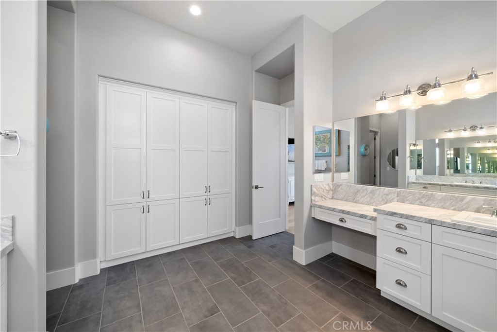 1594 Eucalyptus Road Nipomo, CA 93444 - Photo 41 of 75 a spacious bathroom with a granite countertop sink and a mirror