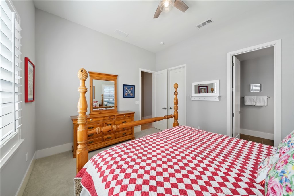 1594 Eucalyptus Road Nipomo, CA 93444 - Photo 45 of 75 a bedroom with a large bed and a chandelier