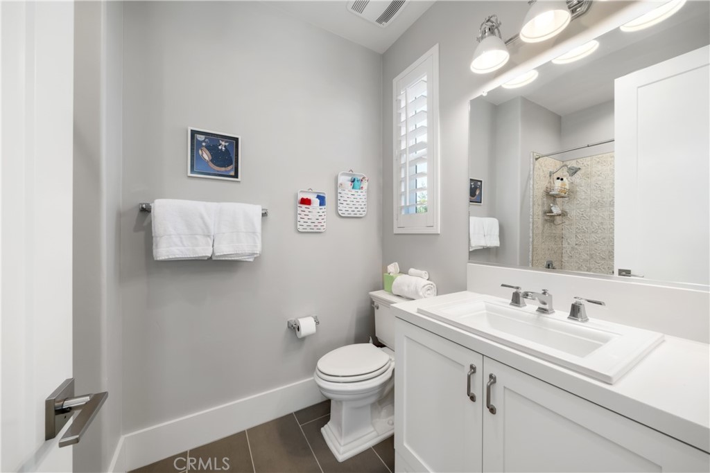 1594 Eucalyptus Road Nipomo, CA 93444 - Photo 46 of 75 a bathroom with a granite countertop sink a toilet and a mirror