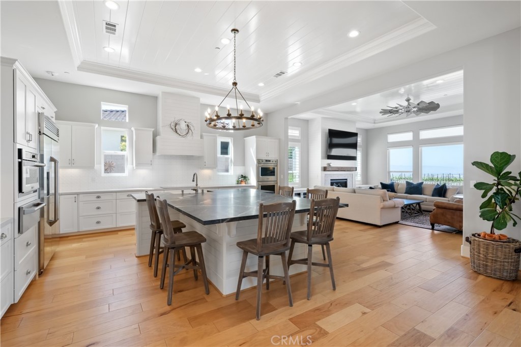 1594 Eucalyptus Road Nipomo, CA 93444 - Photo 8 of 75 a view of a dining room and livingroom with furniture wooden floor a chandelier