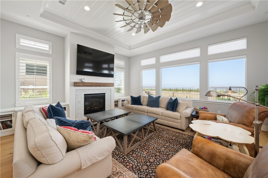 1594 Eucalyptus Road Nipomo, CA 93444 - Photo 9 of 75 a living room with furniture a flat screen tv and a fireplace