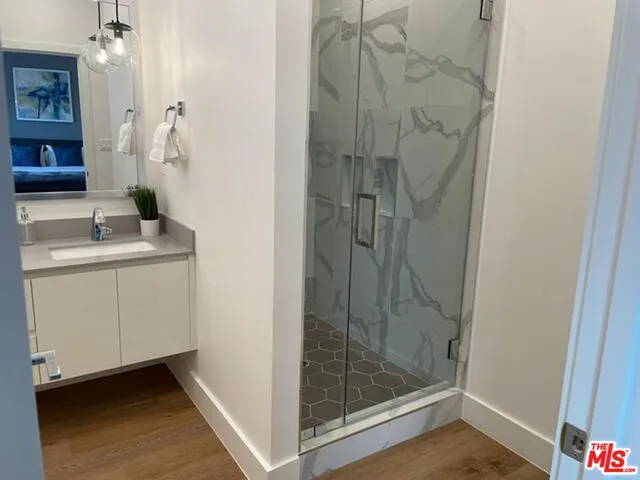 a bathroom with a shower and sink
