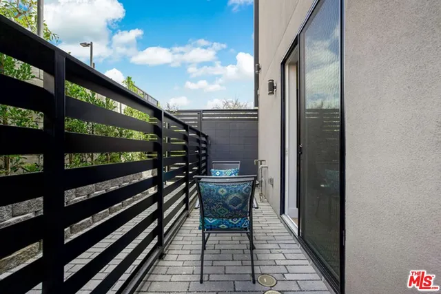 a balcony view with a glass door