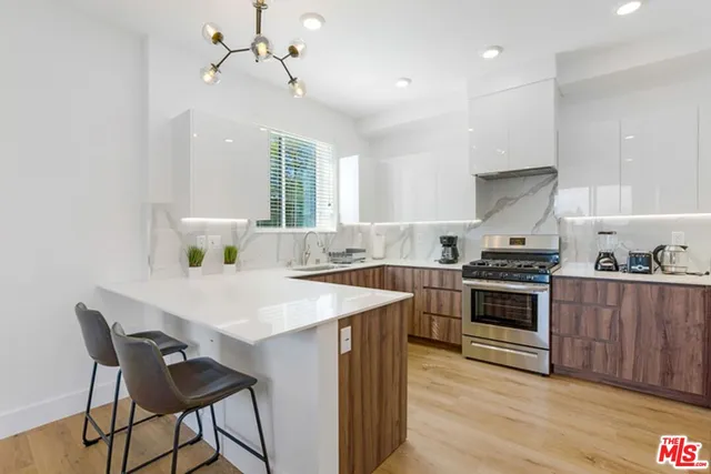 a kitchen with a stove a sink and a refrigerator