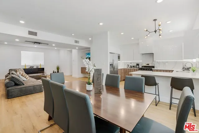 a large kitchen with a table and chairs