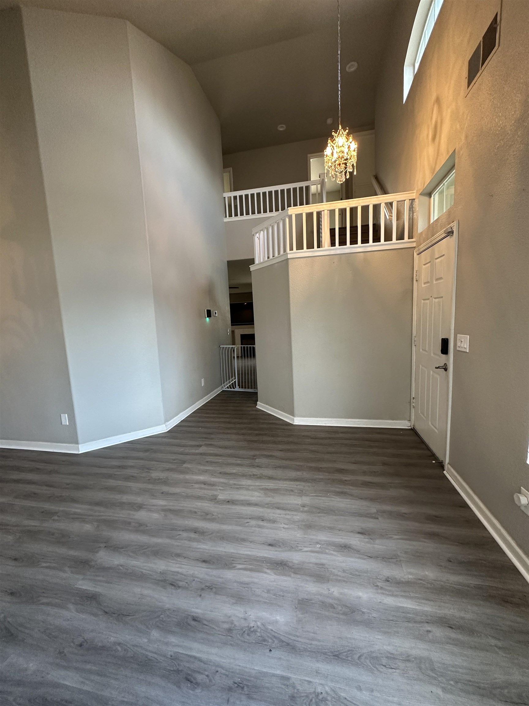 756 Rubier Way Rio Vista, CA 94571 - Photo 5 of 11 Unfurnished living room with suspended lighting, dark wood-style floors, and a high ceiling
