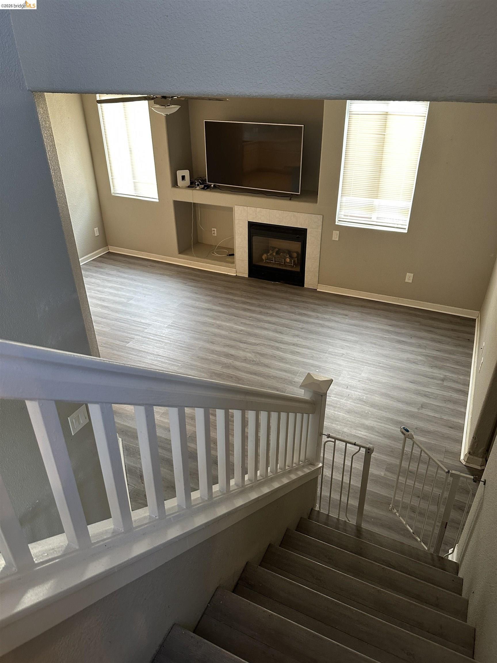 756 Rubier Way Rio Vista, CA 94571 - Photo 8 of 11 Staircase featuring wood finished floors and a tiled fireplace