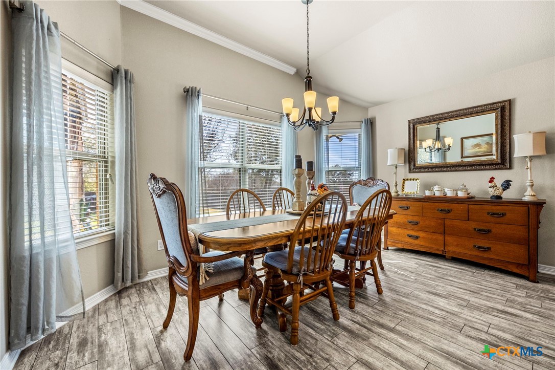 166 Mountain Rose Road Belton, TX 76513 - Photo 15 of 37 a view of a dining room with furniture window and wooden floor