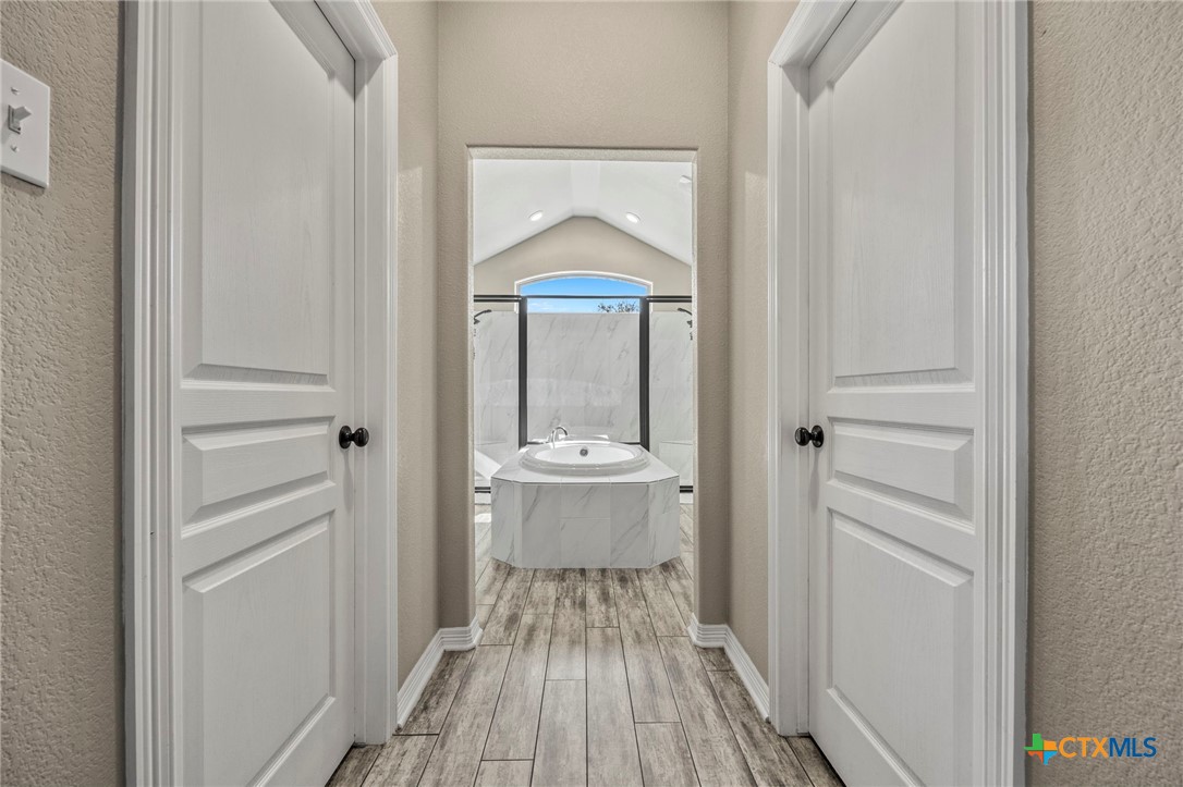 166 Mountain Rose Road Belton, TX 76513 - Photo 18 of 37 a view of bathroom with bathtub wooden floor and window