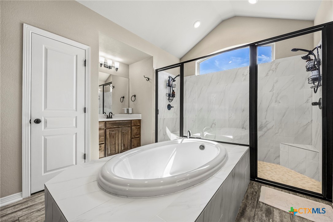 166 Mountain Rose Road Belton, TX 76513 - Photo 19 of 37 a bathroom with a bathtub and a shower