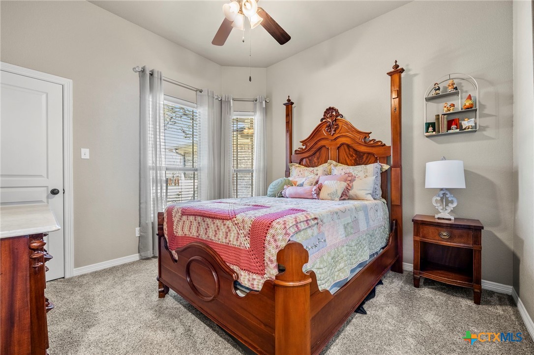 166 Mountain Rose Road Belton, TX 76513 - Photo 22 of 37 a bedroom with a bed and a painting on the wall