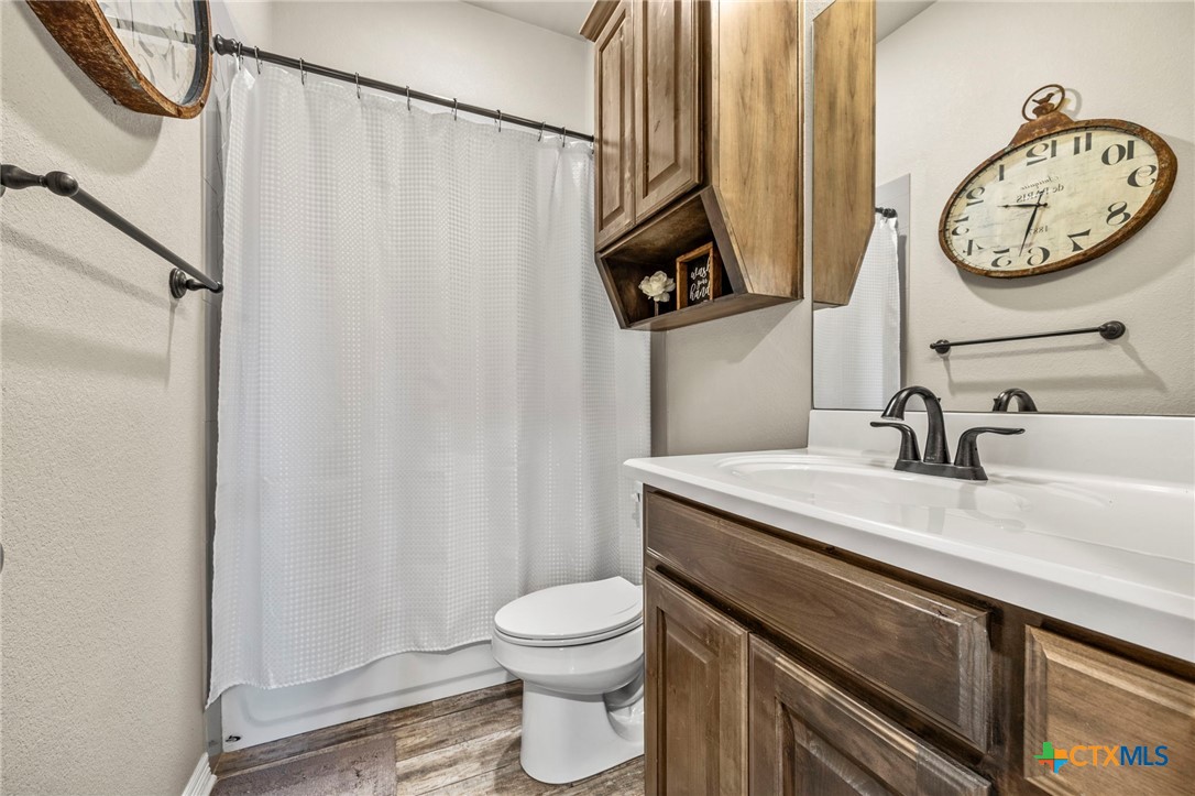 166 Mountain Rose Road Belton, TX 76513 - Photo 25 of 37 a bathroom with a toilet a sink and a mirror