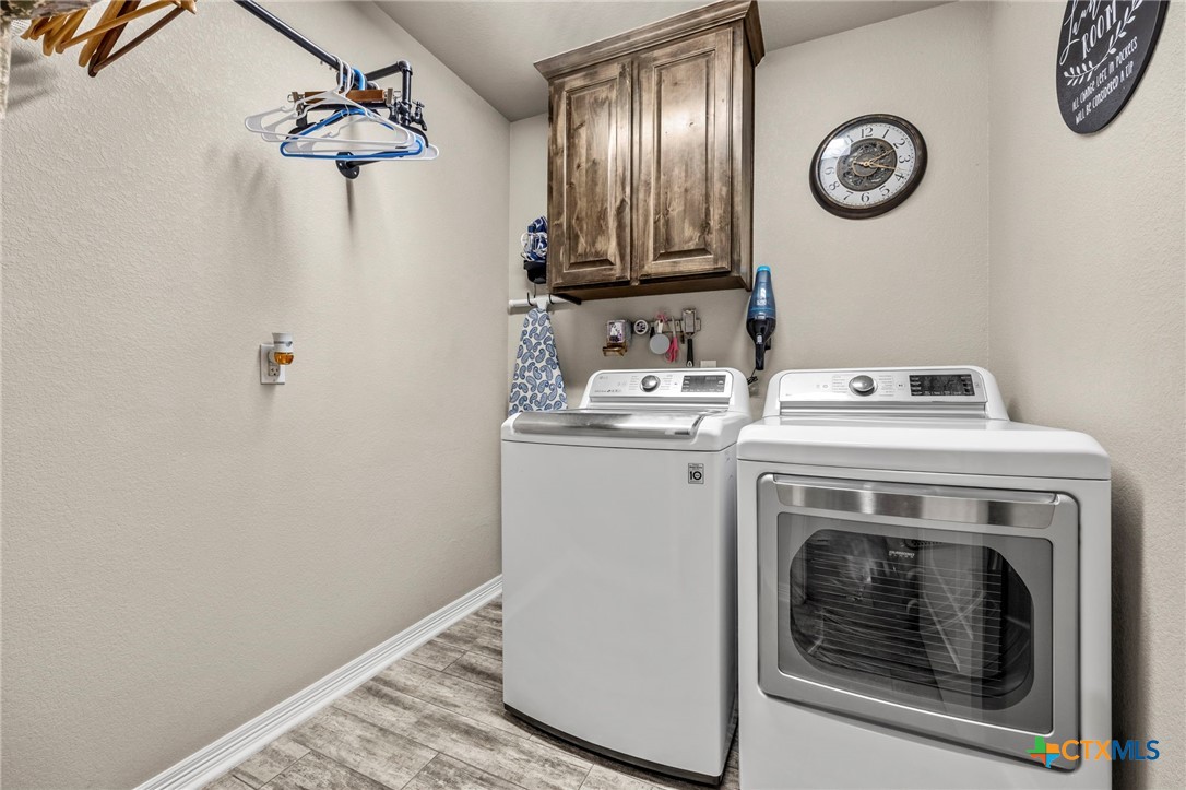 166 Mountain Rose Road Belton, TX 76513 - Photo 26 of 37 a view of a storage and utility room with washer and dryer